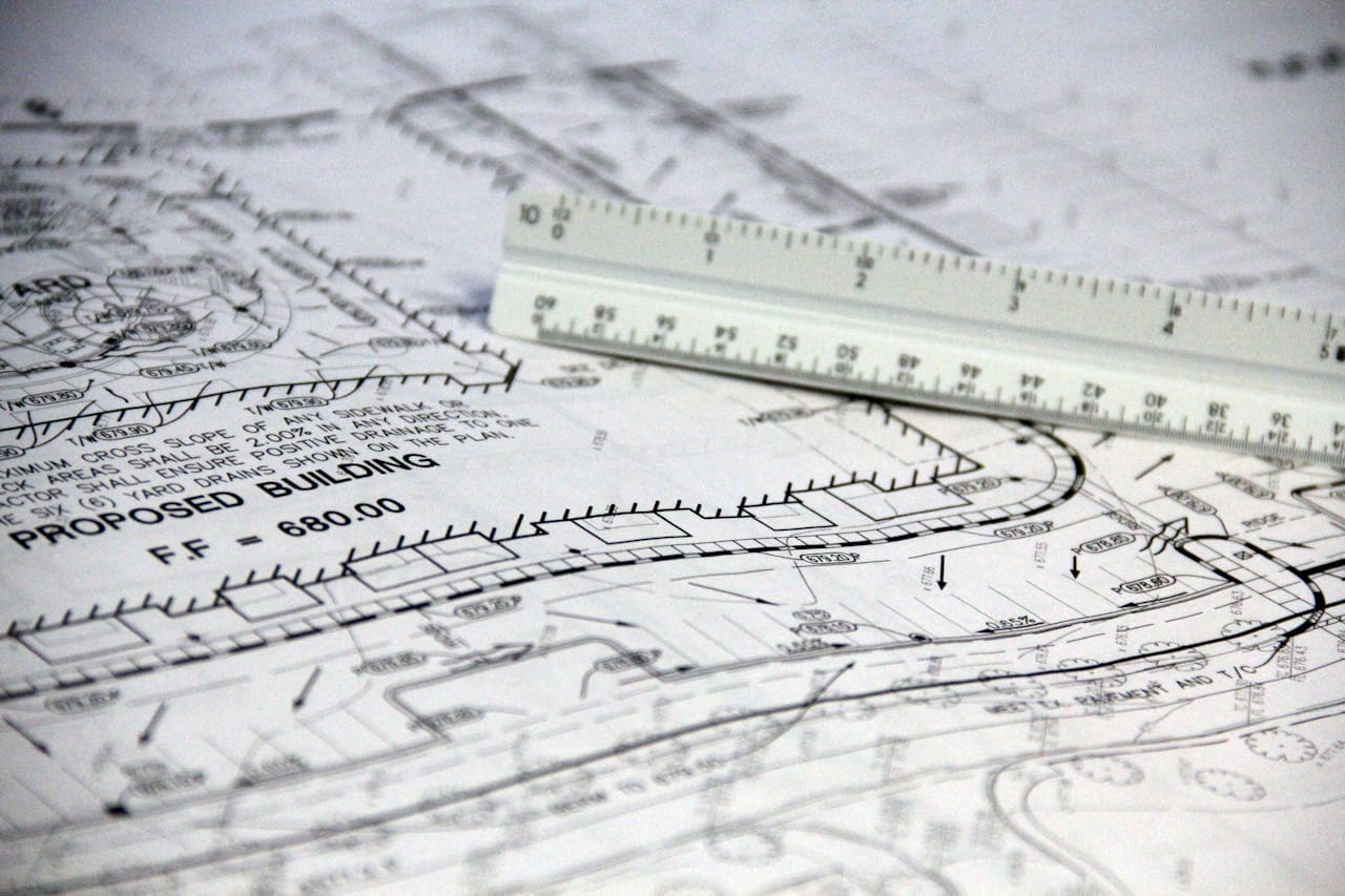 White ruler on white printed paper with planning diagrams